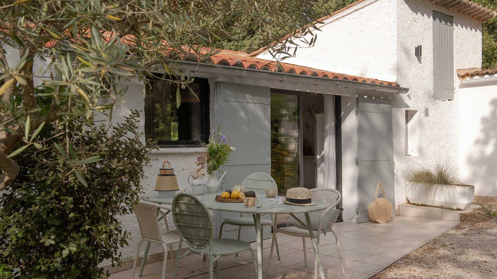 Terrasse ombragée et façade du cabanon rénové, en Provence